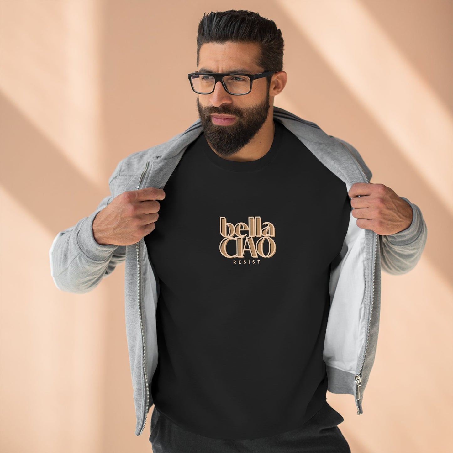 Man wearing a black t-shirt with 'bella CIAO' text, beige background