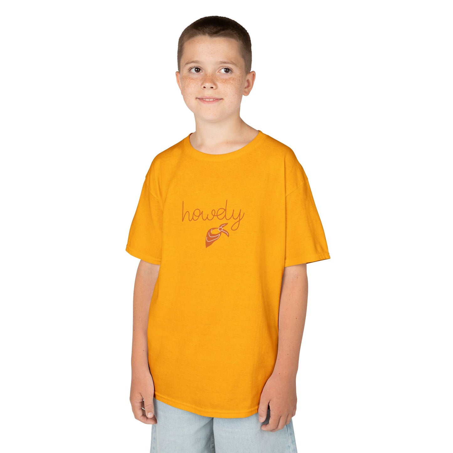 Child wearing a mustard yellow t-shirt with 'howdy' and a cowboy boot graphic on a white background