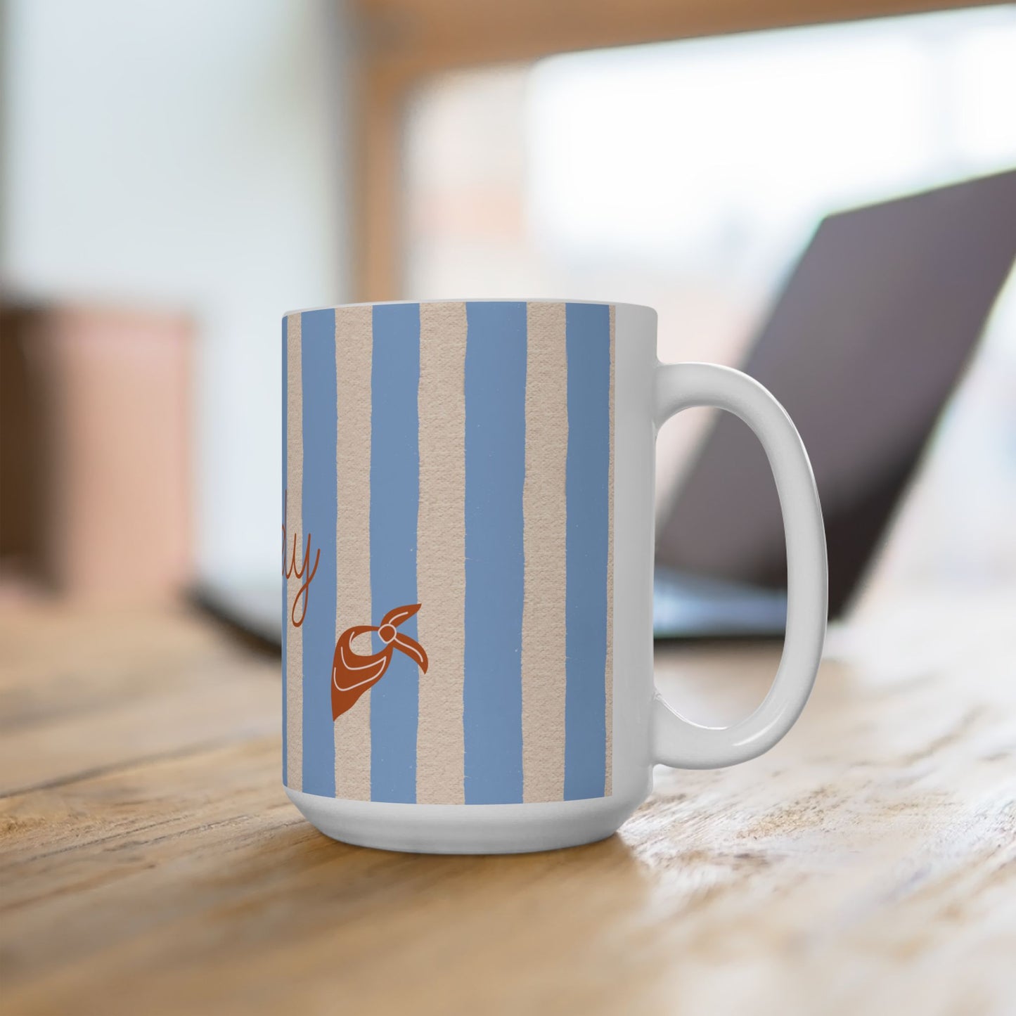 Mug with blue and beige striped pattern on a wooden surface