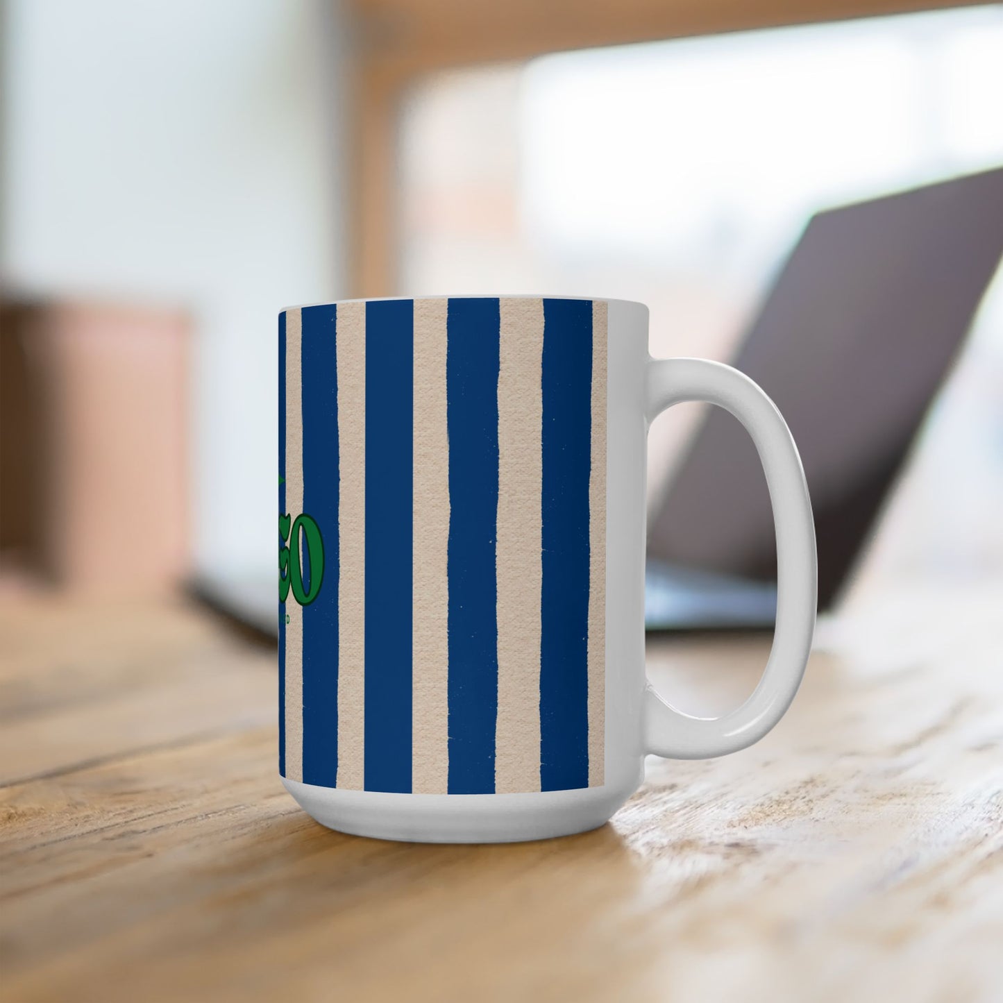 Mug with blue and beige stripes on a wooden surface