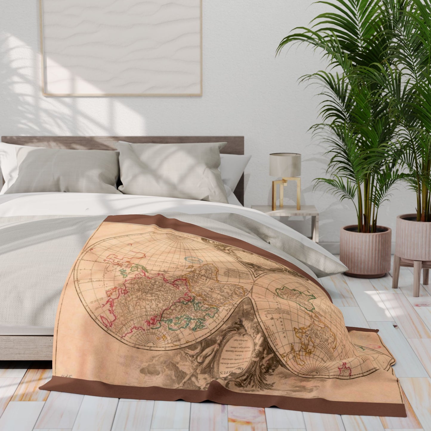 Map-themed blanket draped over a bed in a bright bedroom with plants and decor.