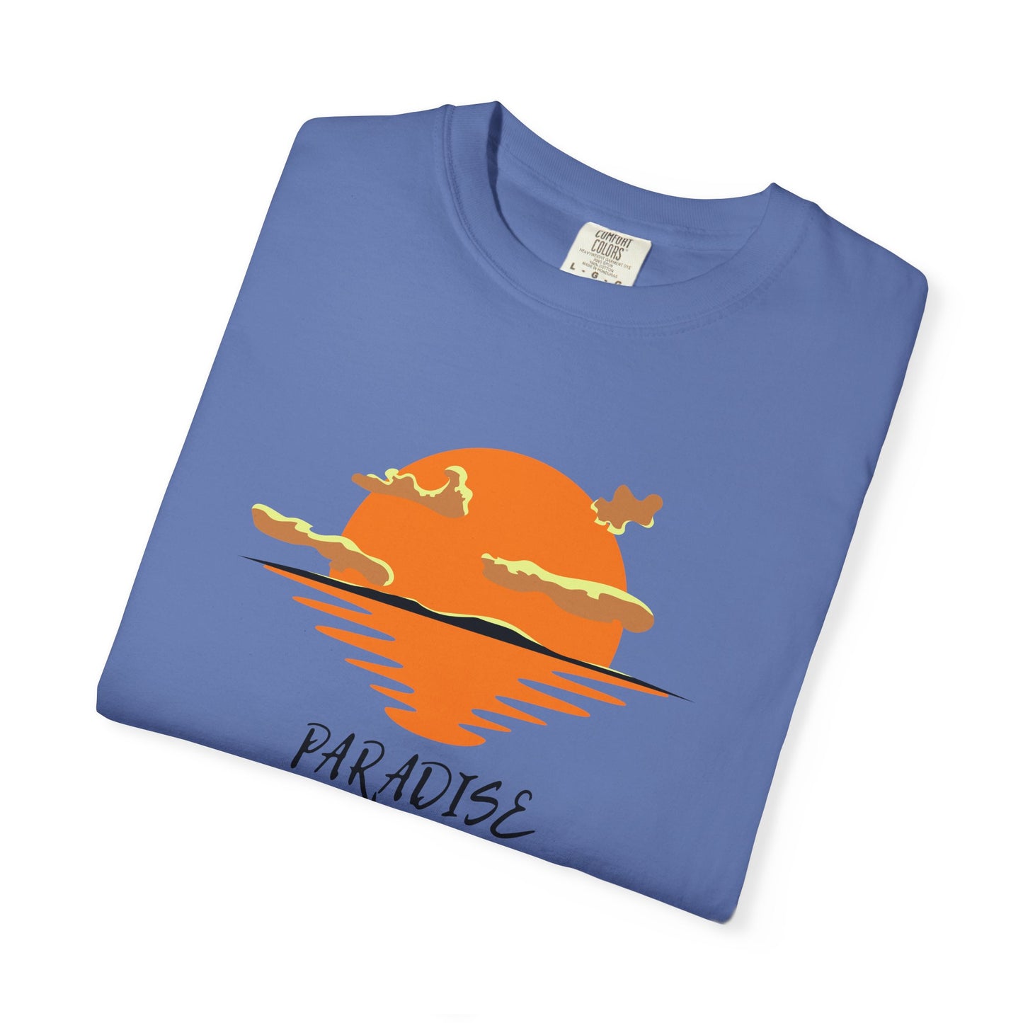 Folded blue t-shirt with orange sunset graphic and 'Paradise' text on a white background
