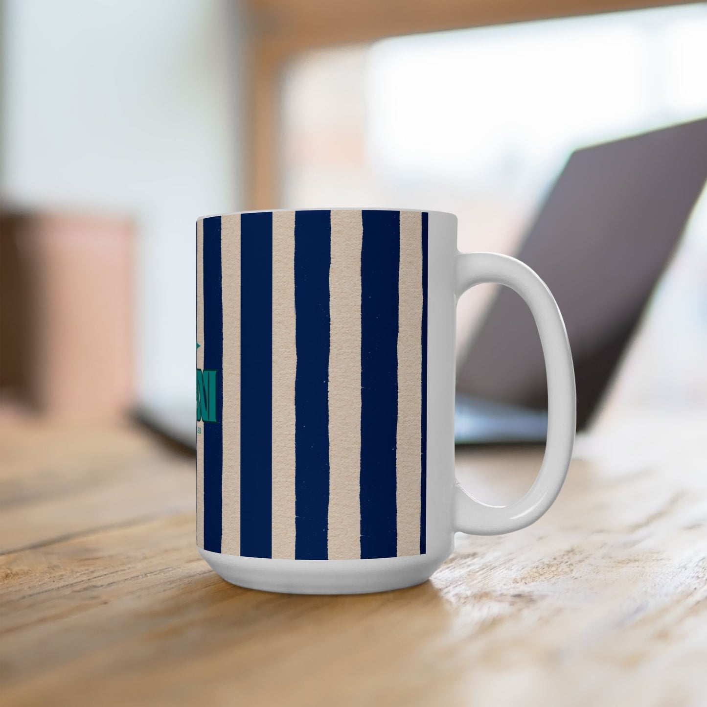 White mug with blue and beige stripes on a wooden surface