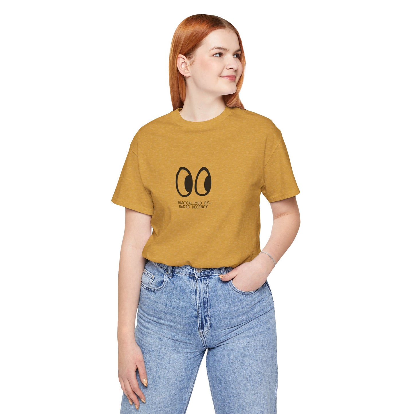 Person wearing a mustard yellow t-shirt with a logo and text, standing against a white background