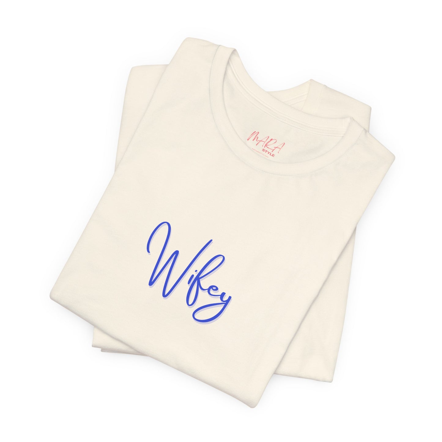 Folded cream-colored tank top with 'Wifey' embroidered in blue on a white background