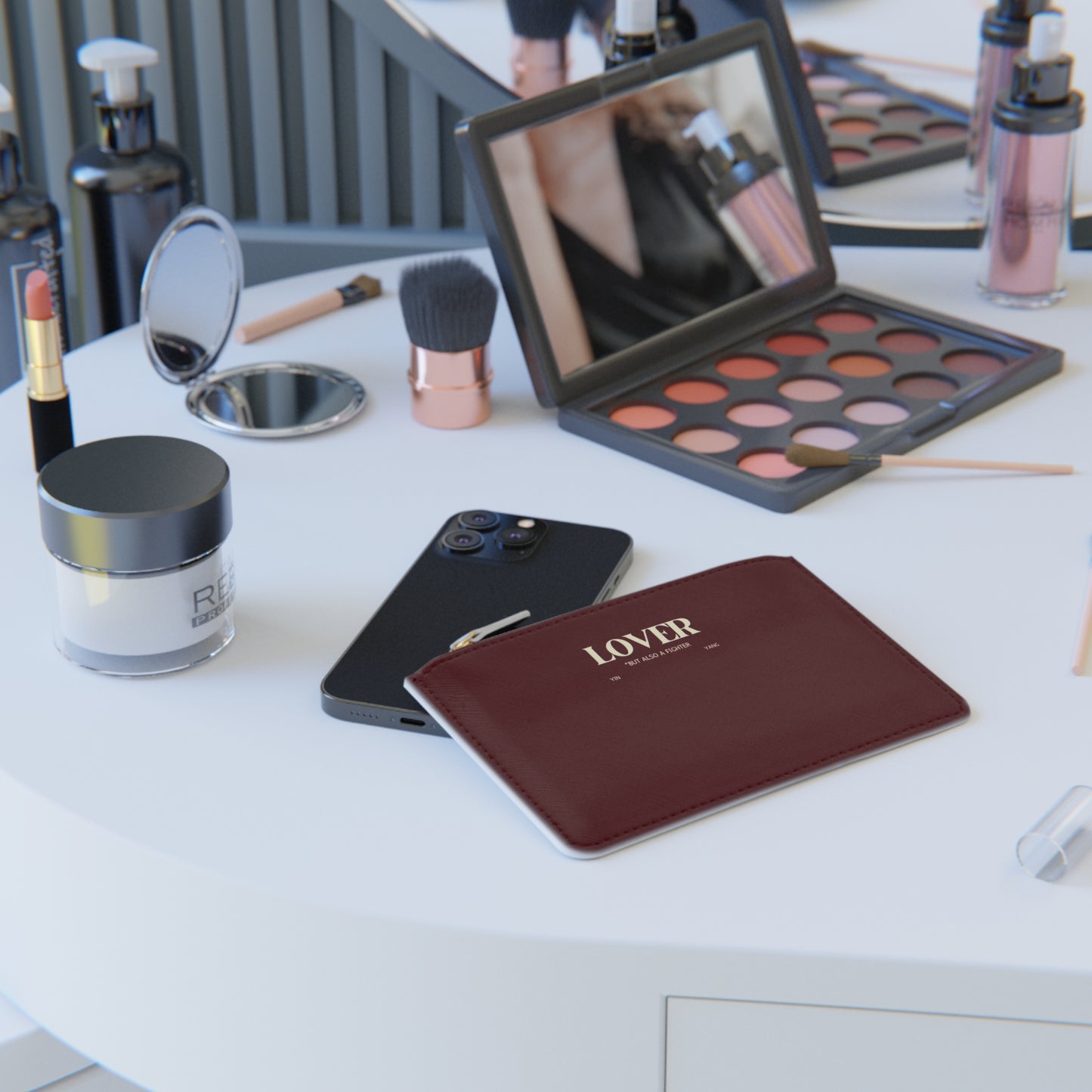 Makeup products including a palette, brushes, and a phone on a white surface.
