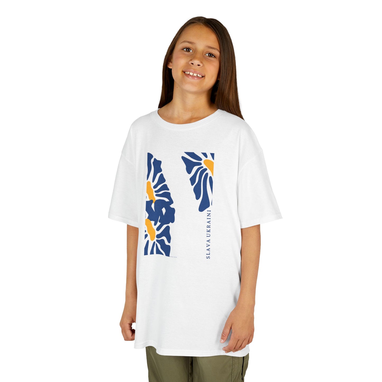 Young girl wearing a white t-shirt with blue and orange graphics on a white background