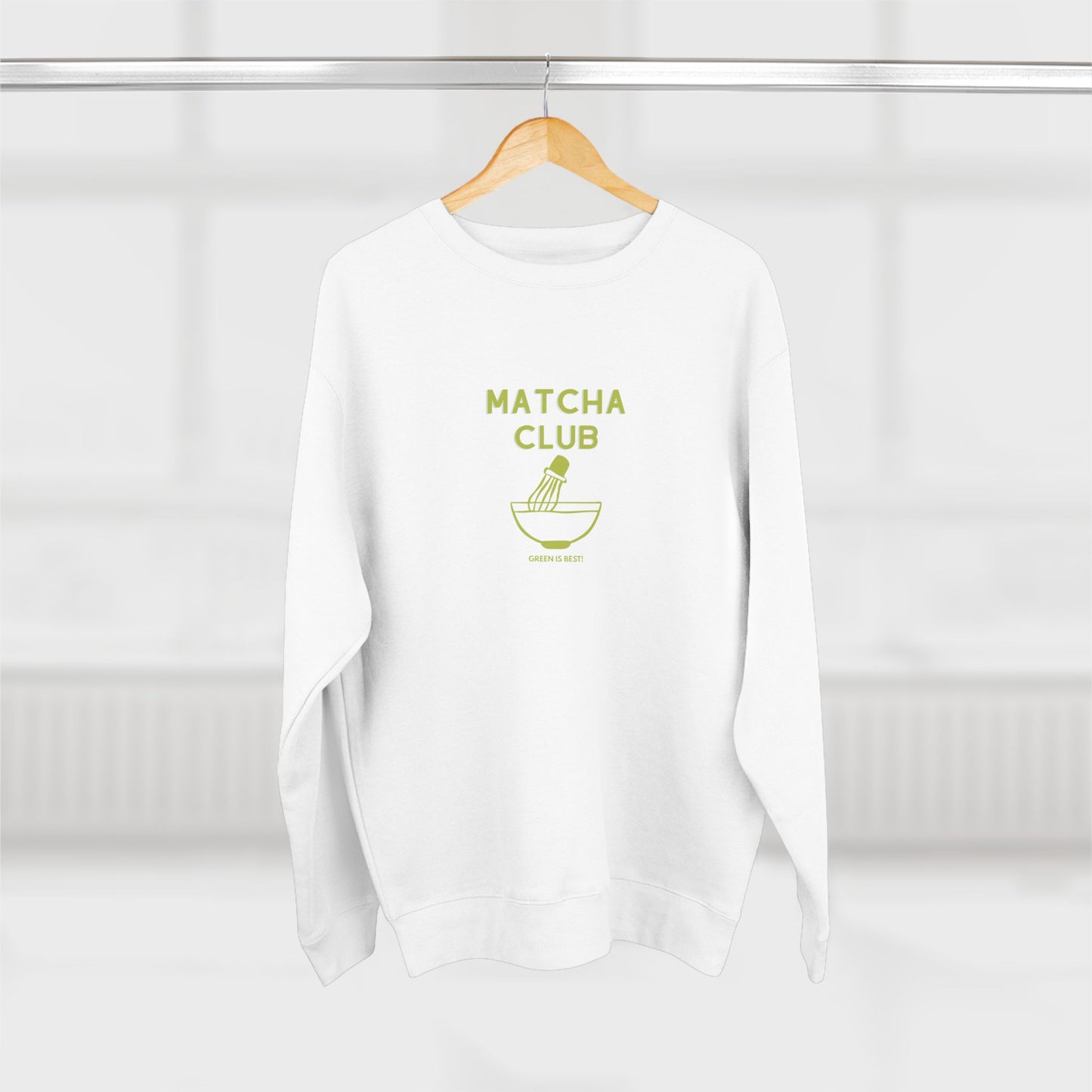 White sweatshirt with 'Matcha Club' text on a wooden hanger against a white background