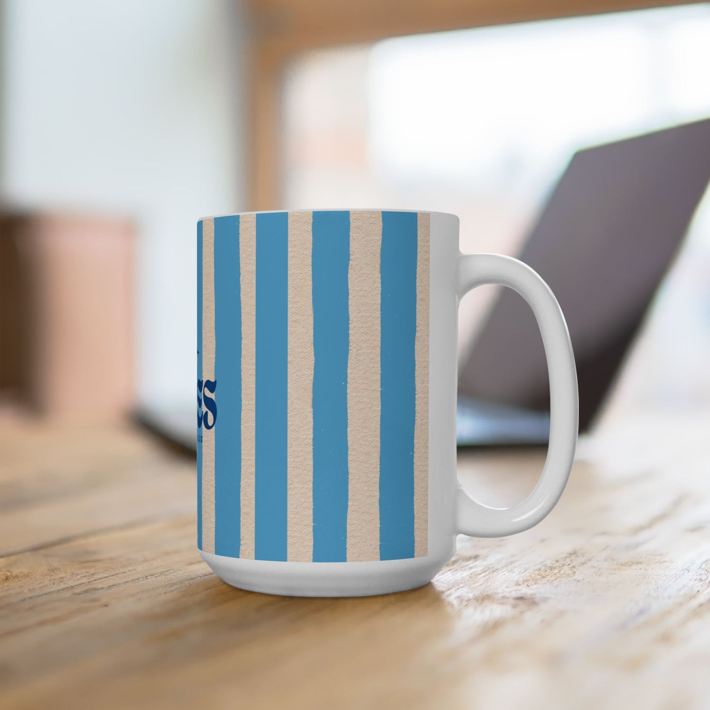 Mug with blue and beige striped pattern on a wooden surface