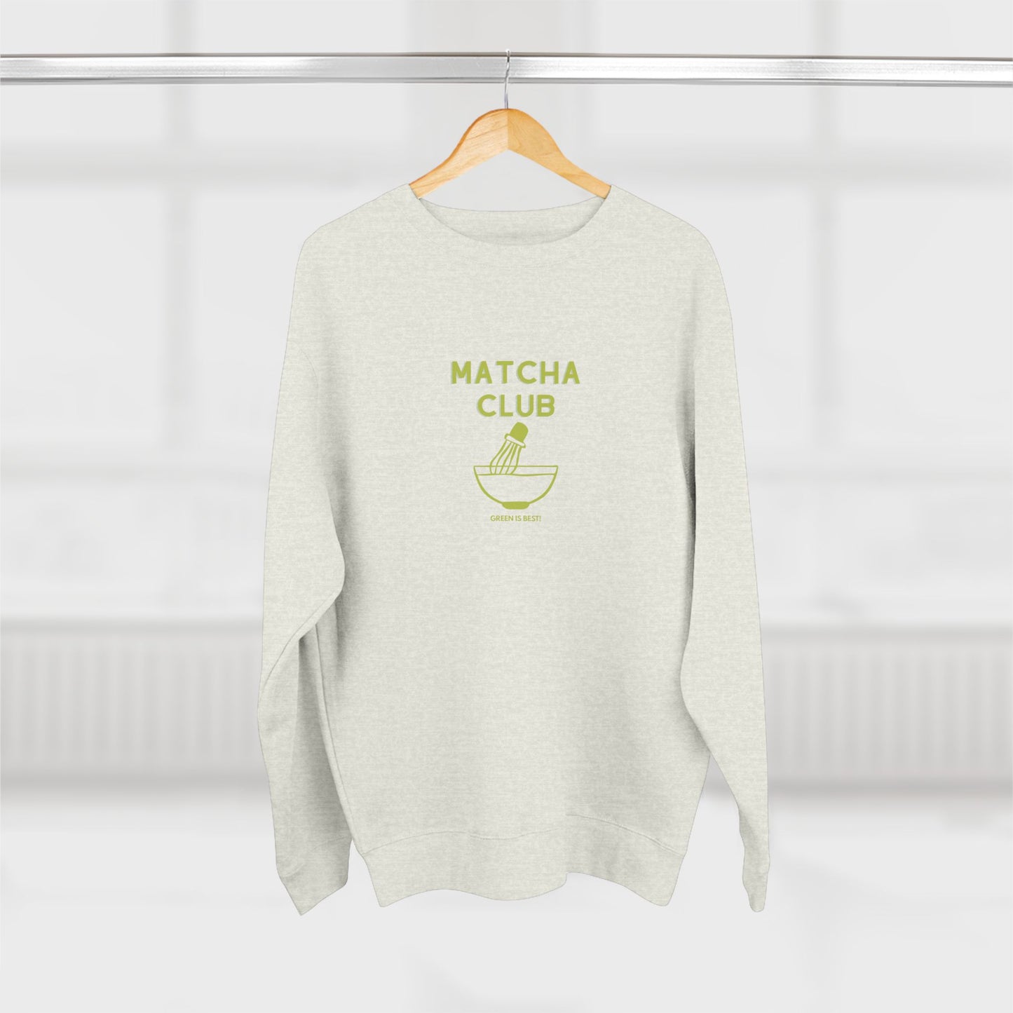 Light gray sweater with 'Matcha Club' text and logo on a hanger against a white background