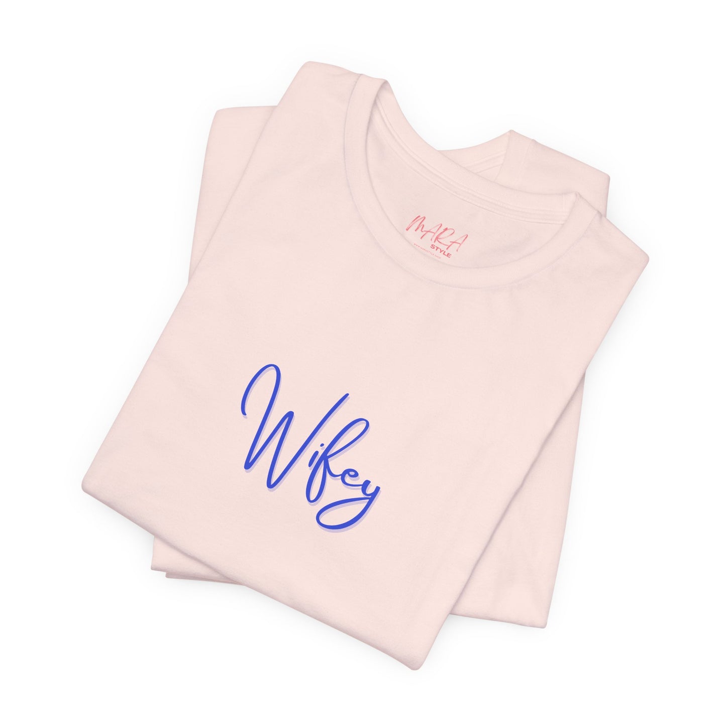 Folded pink tank top with 'Wifey' printed on it against a white background