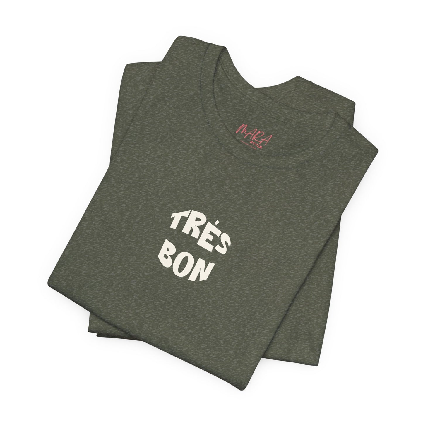 Folded green t-shirt with 'TRèS BON' text on a white background