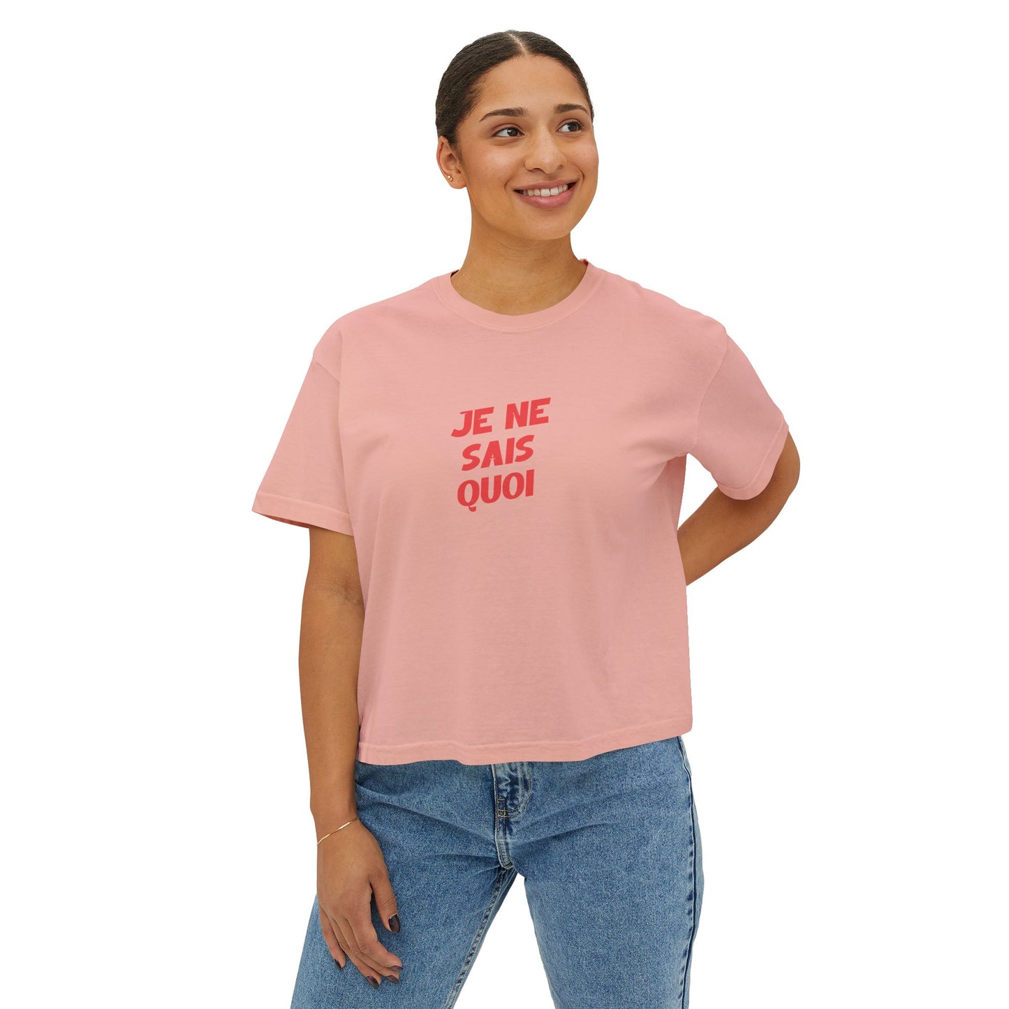 Person wearing a pink t-shirt with red text on a white background