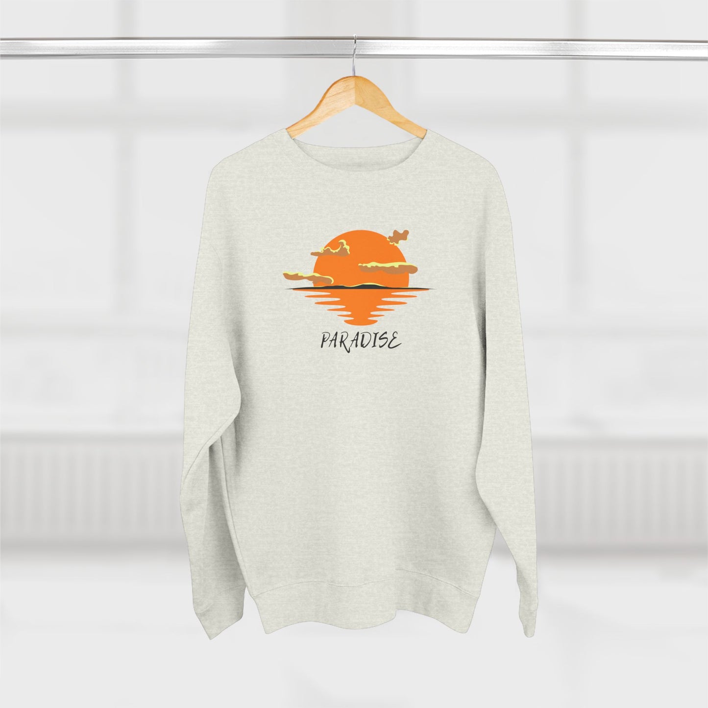 White sweater with a sunset graphic and 'Paradise' text on a white background