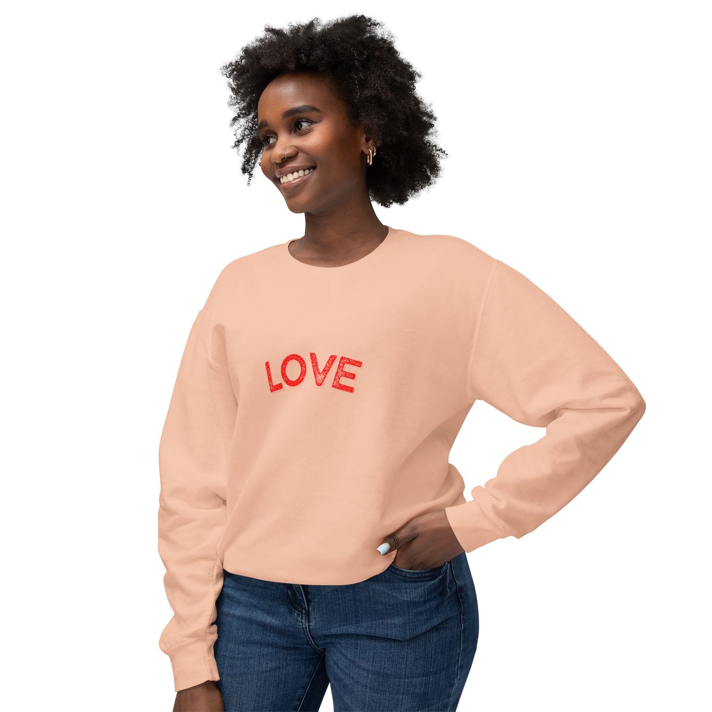 Woman wearing a peach sweatshirt with 'LOVE' in red text on a white background