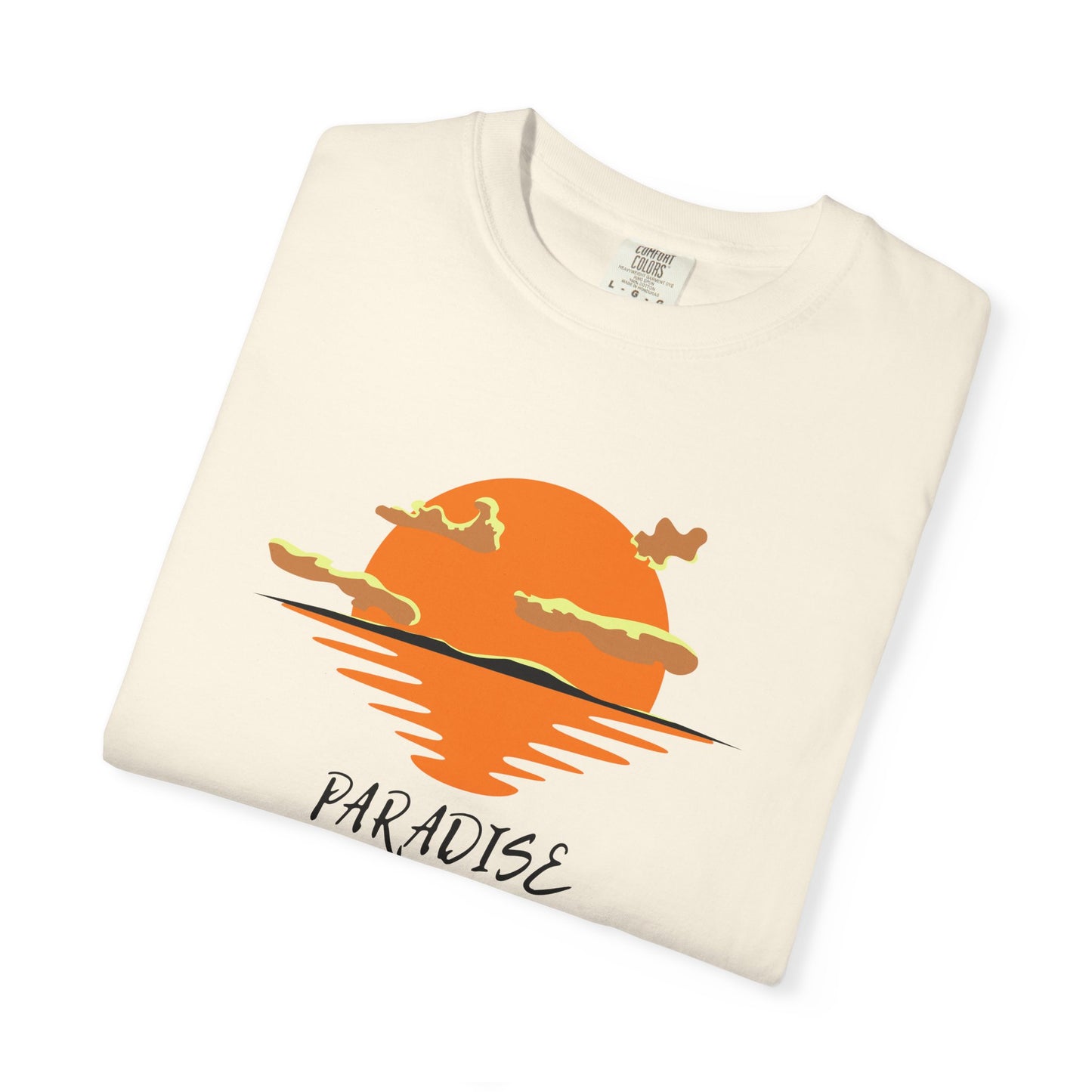 Folded t-shirt with a sunset design and 'Paradise' text on a white background