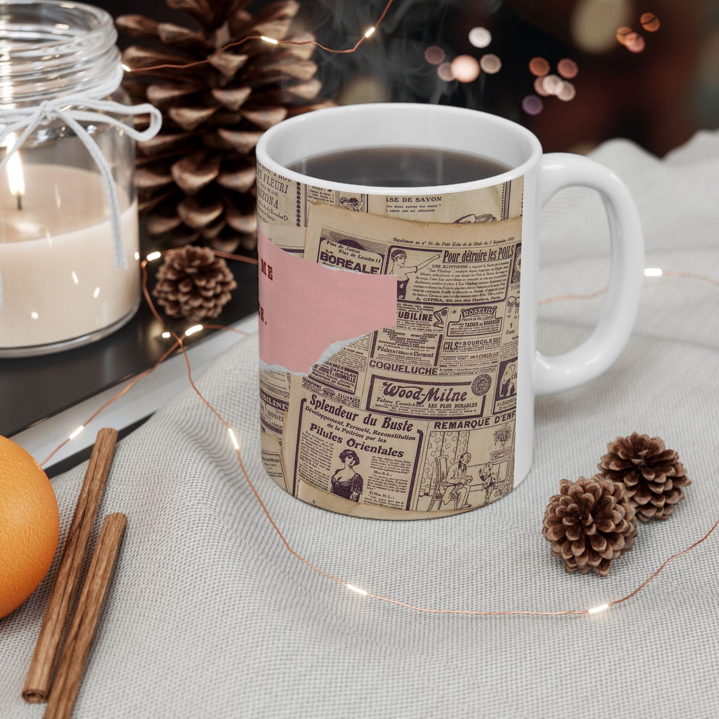 Mug with newspaper design on a table with decorative items