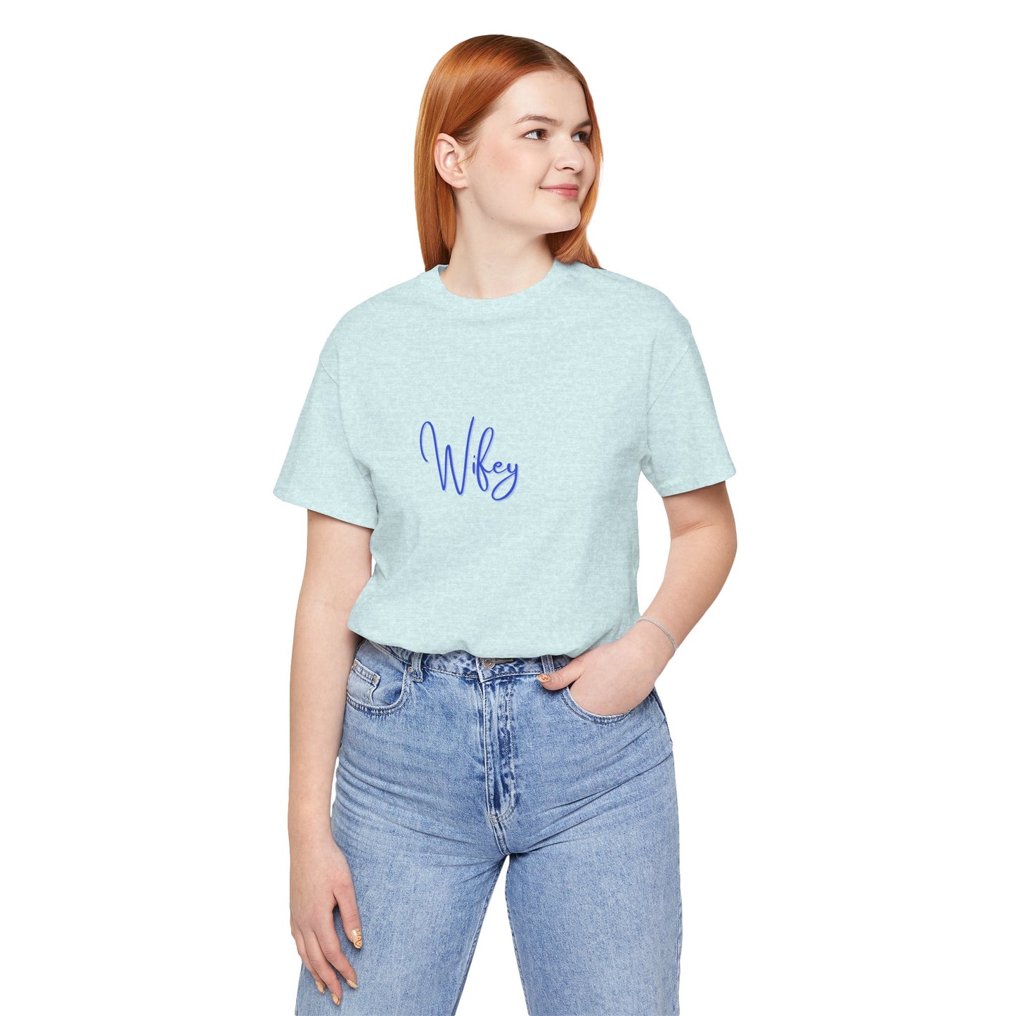 Person wearing a light blue t-shirt with 'Wifey' text and jeans on a white background