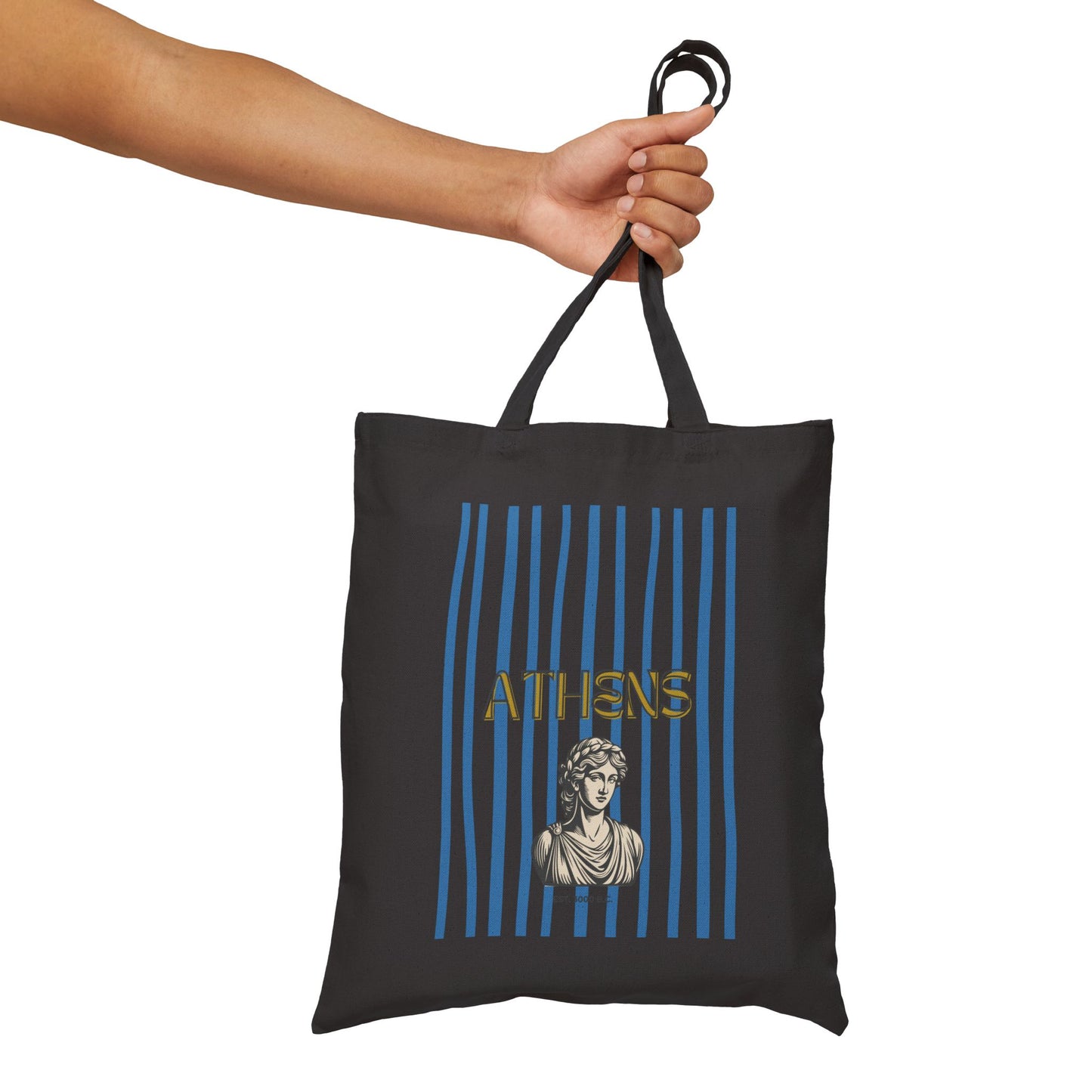 Black tote bag with 'Athens' design held by a hand on a white background