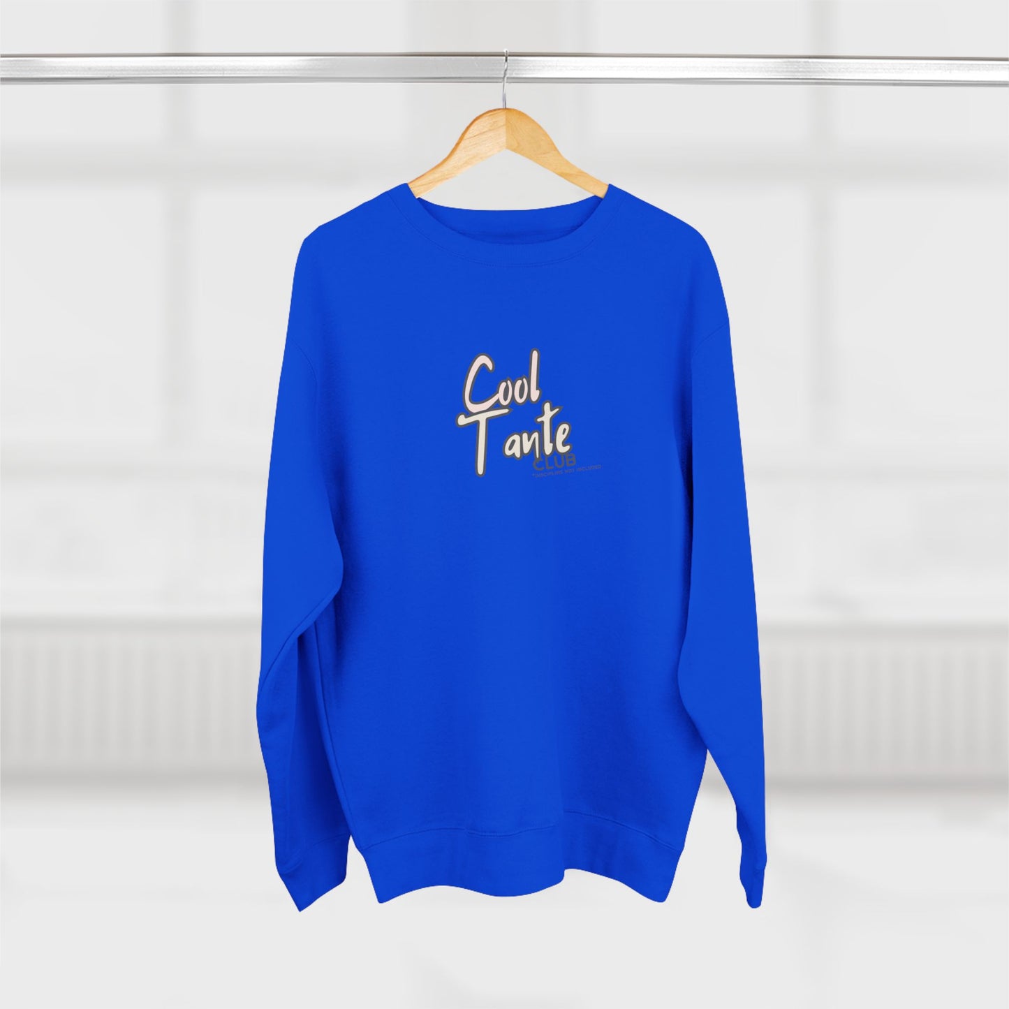 Blue sweatshirt with 'Cool Tante' text on a wooden hanger against a white background