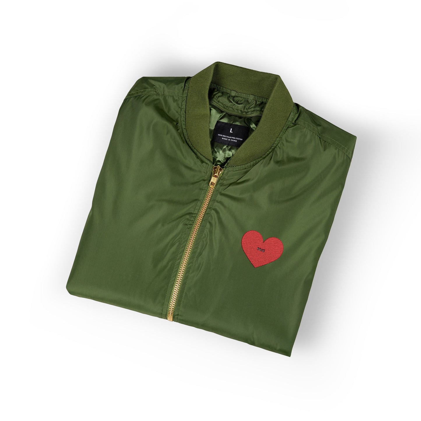 Folded green jacket with a red heart design on a white background
