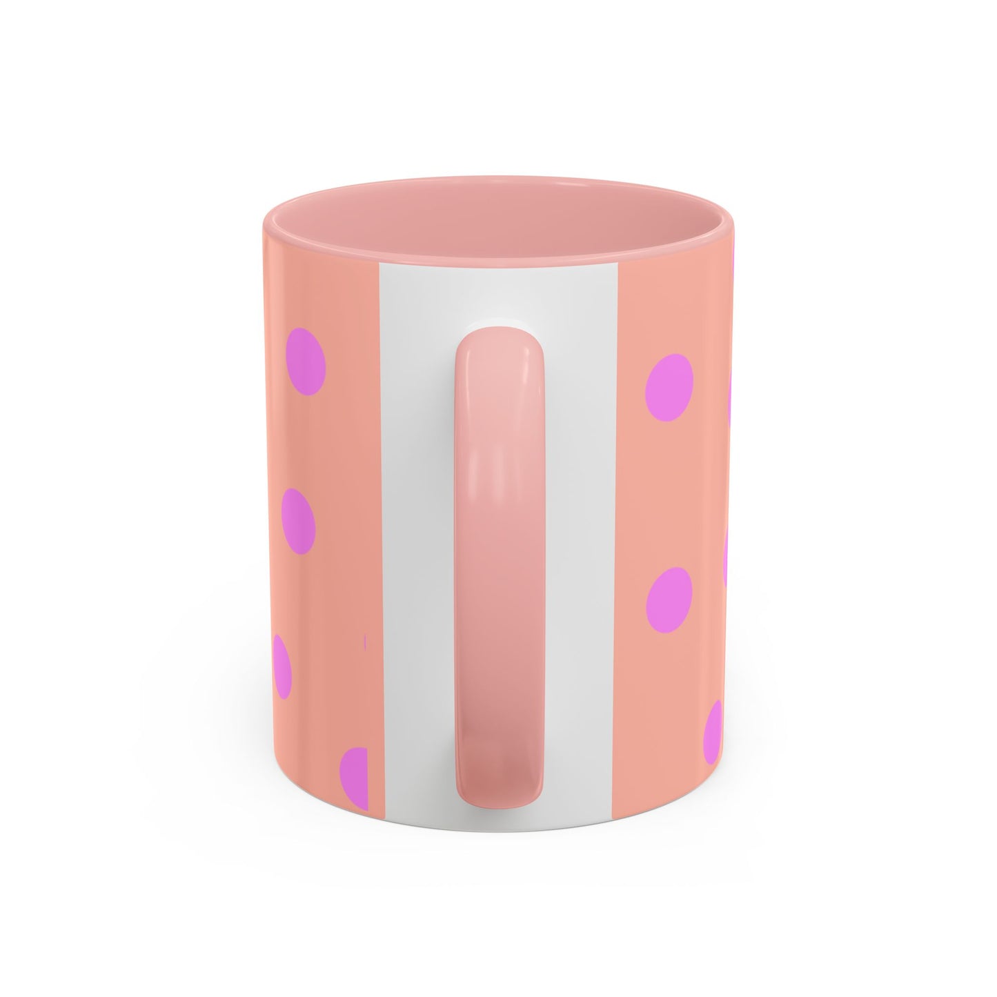 Pink mug with white handle and polka dot pattern on a white background