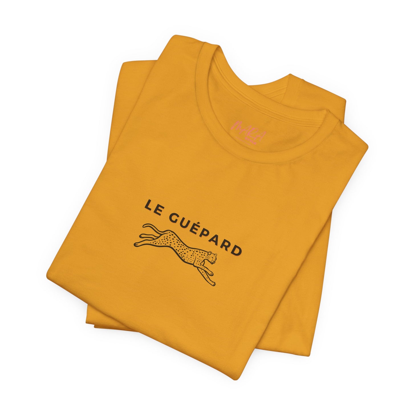Folded mustard yellow t-shirt with 'Le Guépard' logo on a white background