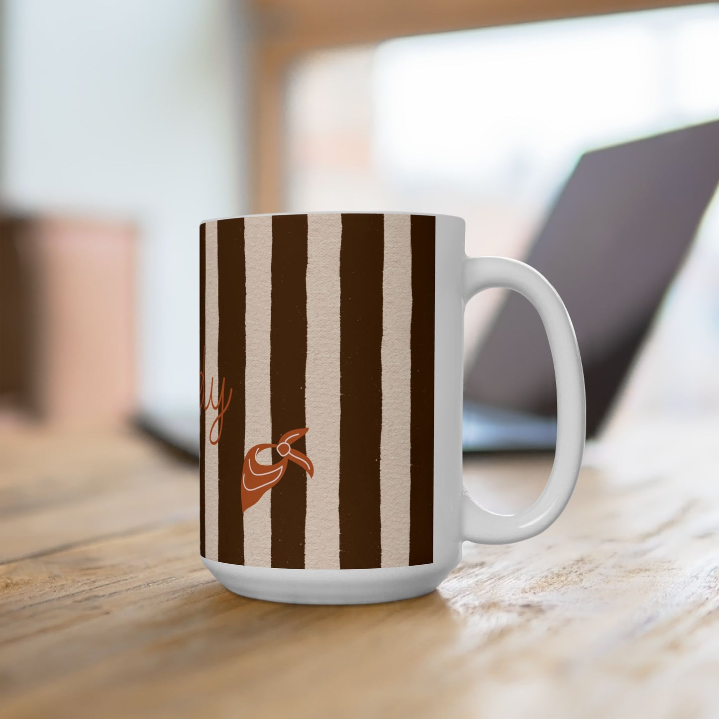 White mug with brown and beige striped design on a wooden surface