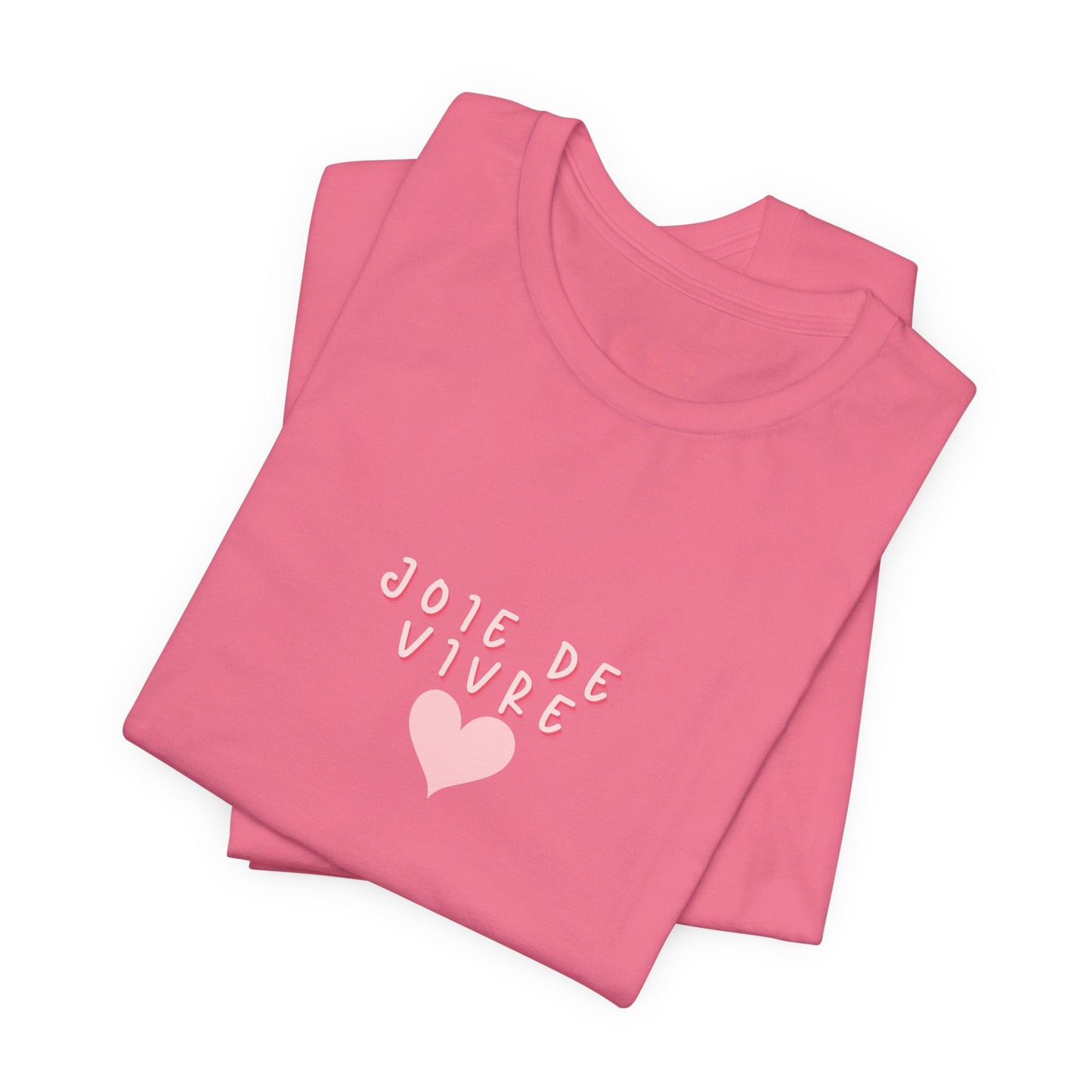 Folded pink t-shirt with 'J'ole de Vivre' text and heart design on a white background