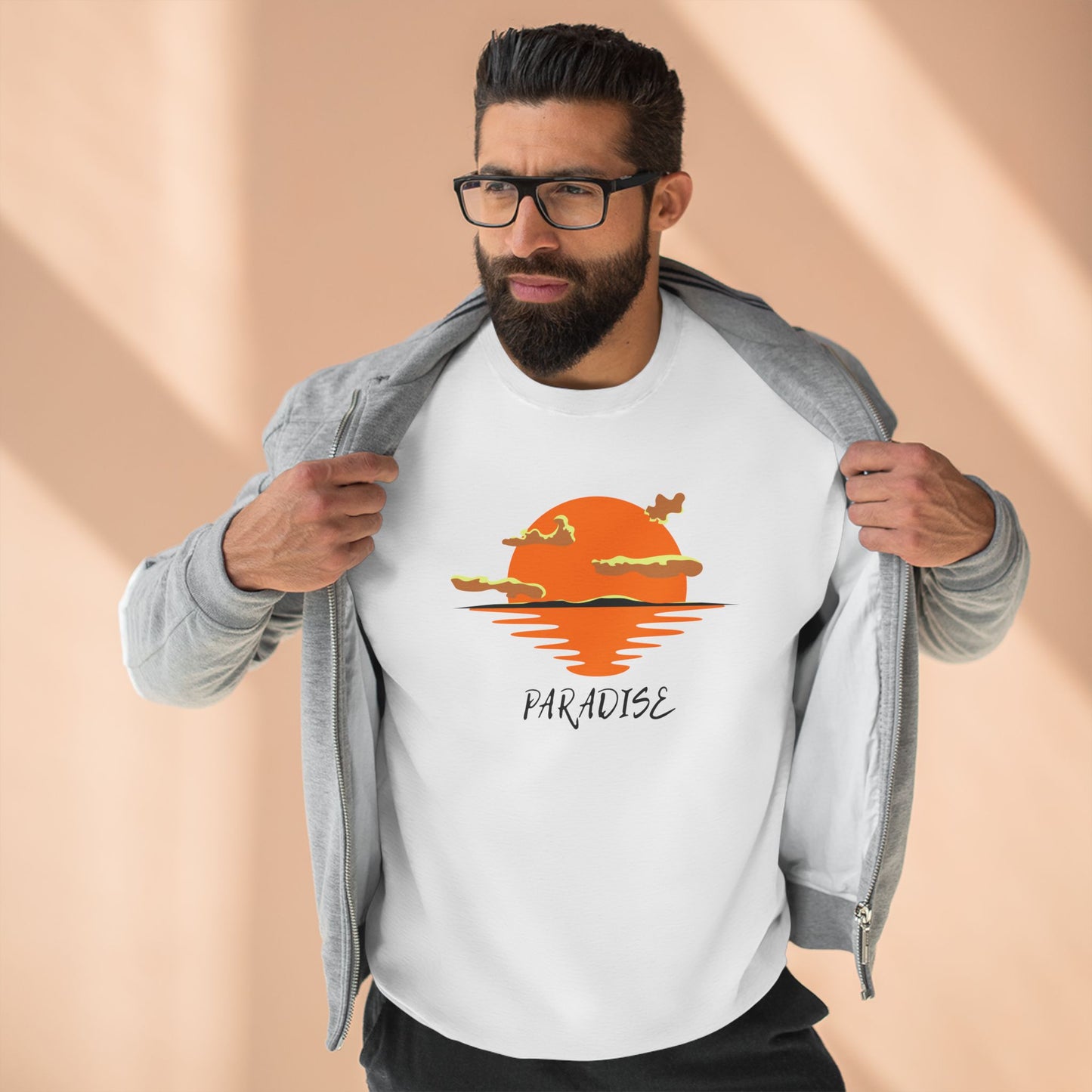 Man wearing a white t-shirt with a sunset design and 'Paradise' text on a beige background
