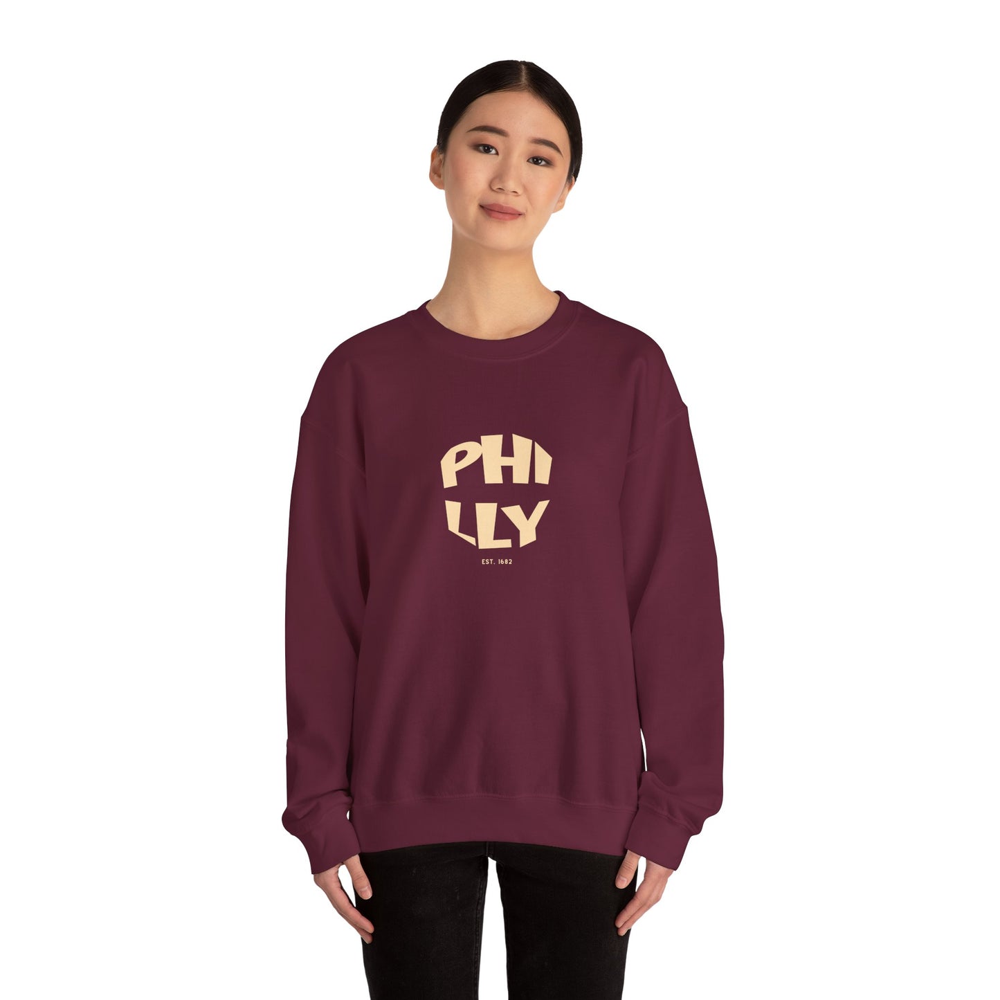 Person wearing a maroon sweatshirt with 'PHILLY' printed on it against a white background
