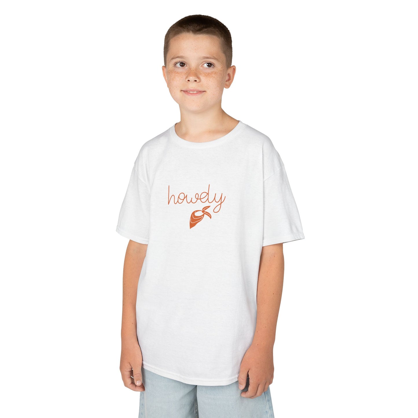 Child wearing a white t-shirt with 'howdy' and a sheriff's badge graphic on a white background