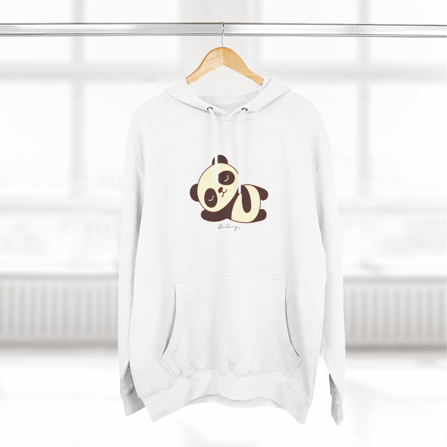 White hoodie with a panda design on a hanger against a white background