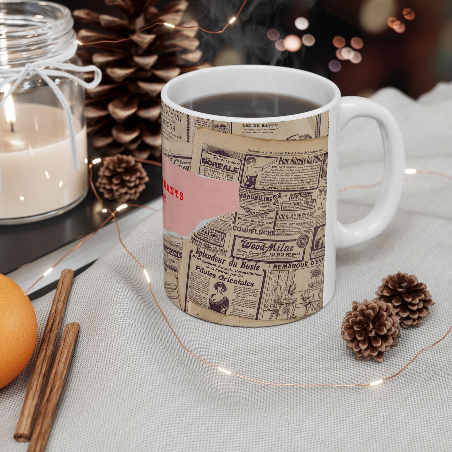 Mug with newspaper design on a table with decorative items