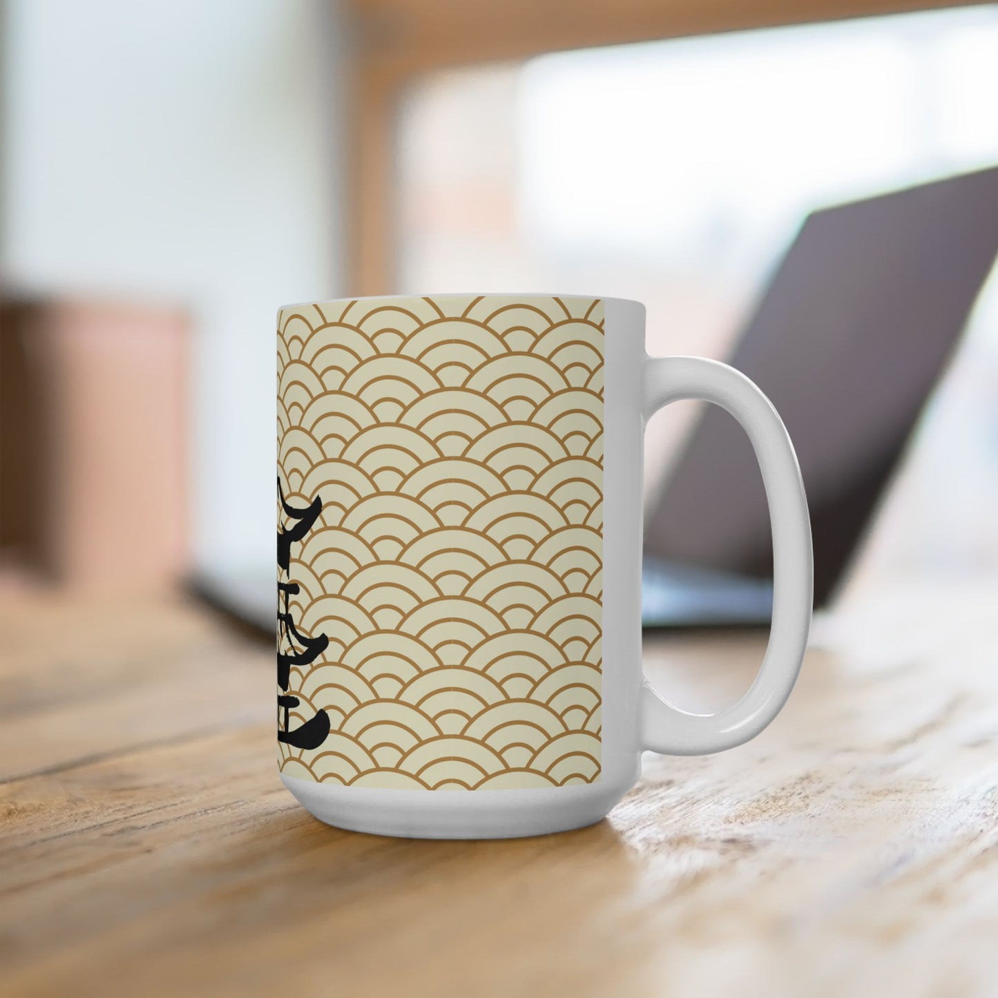 White mug with gold wave pattern and black text on a wooden surface
