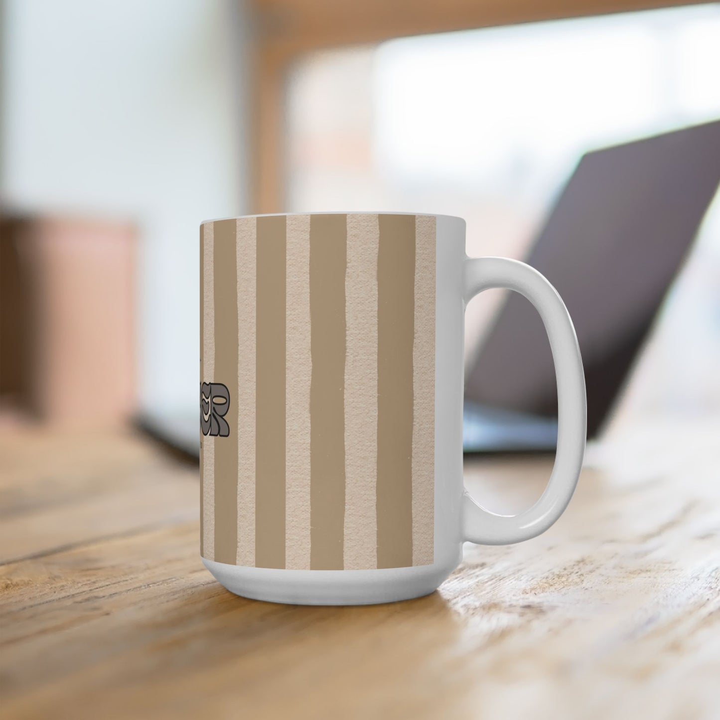 White mug with brown striped pattern on a wooden surface
