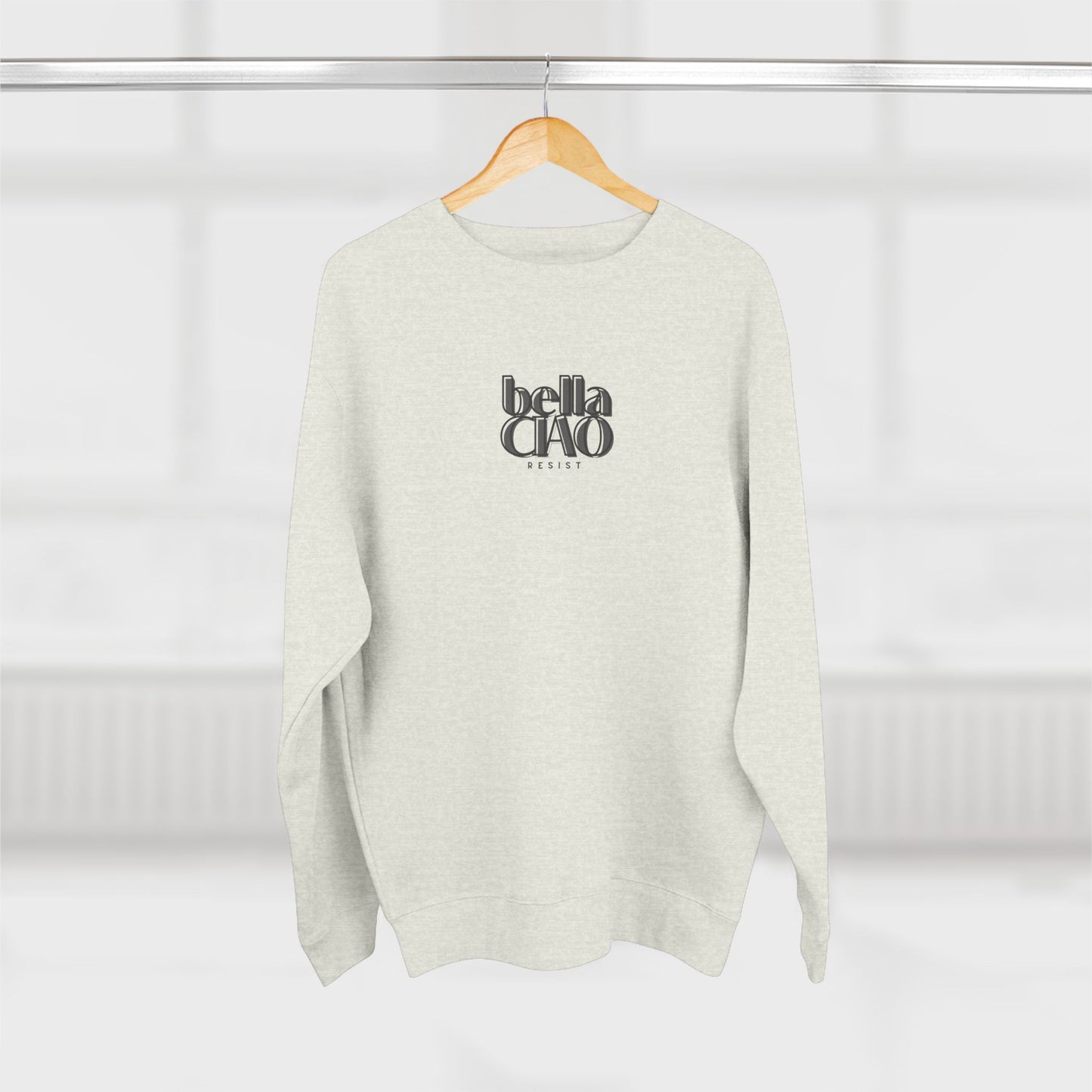 Light gray sweater with 'bella ciao' text on a hanger against a white background