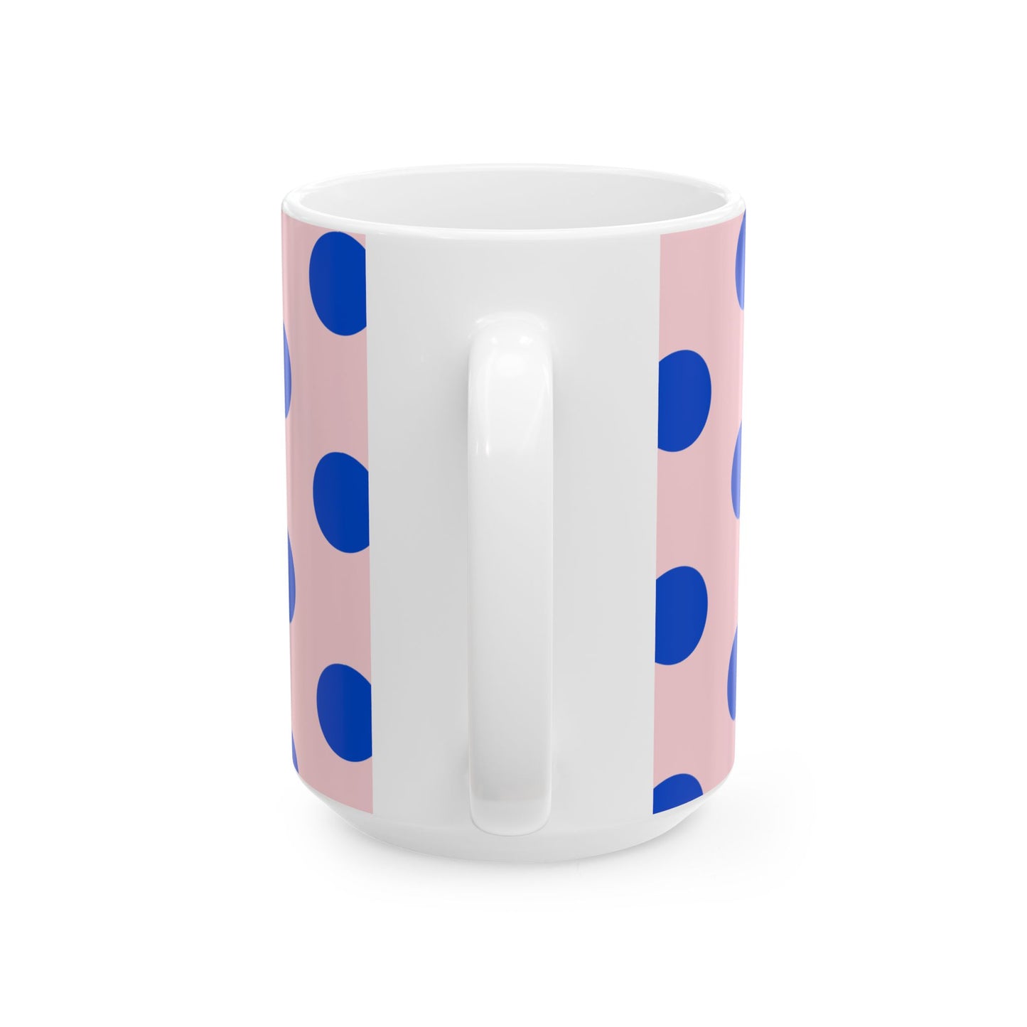 White mug with blue polka dots on a pink background