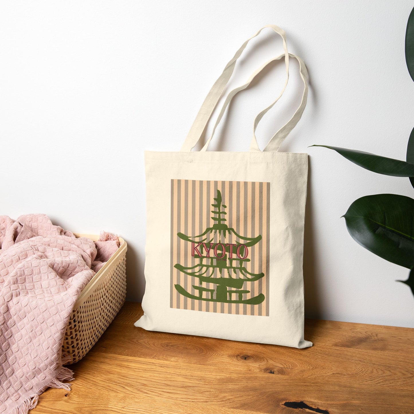 Tote bag with 'Kyoto' design on a wooden surface with a plant in the background