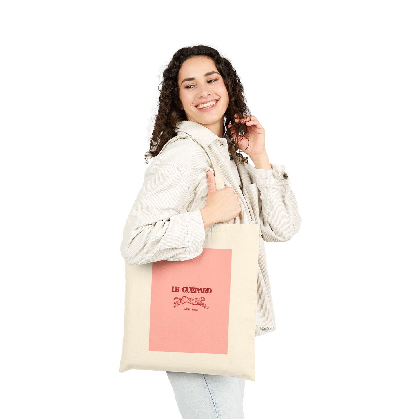Woman holding a tote bag with a pink label on a white background