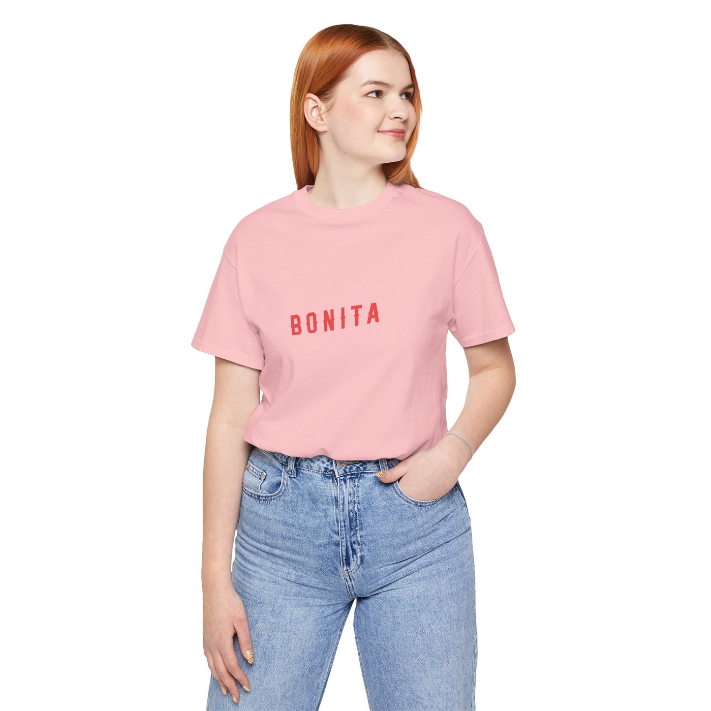 Person wearing a pink t-shirt with 'BONITA' text and blue jeans on a white background