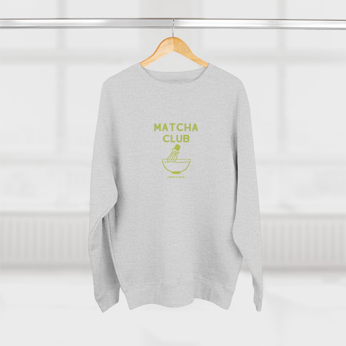 Gray sweatshirt with 'Matcha Club' text and logo on a hanger against a white background