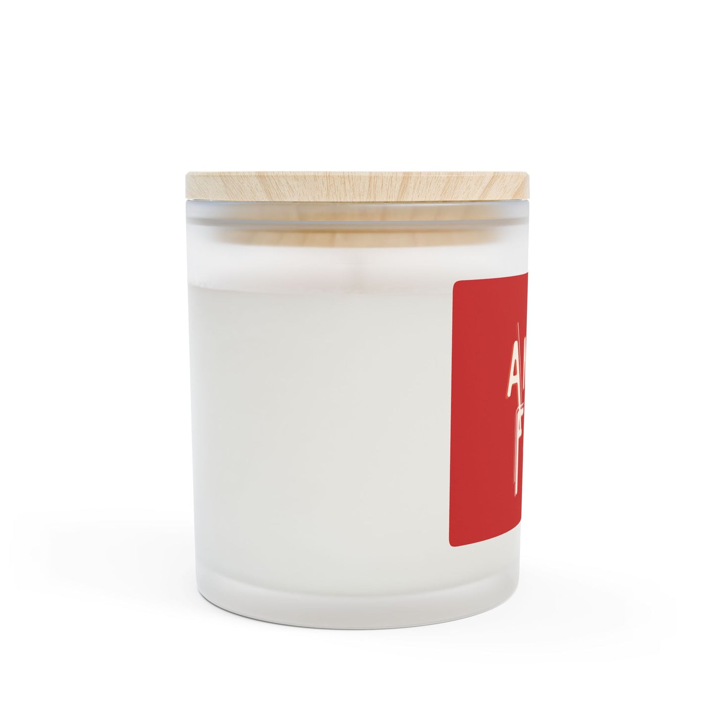 White candle in a glass jar with a wooden lid and red label on a white background
