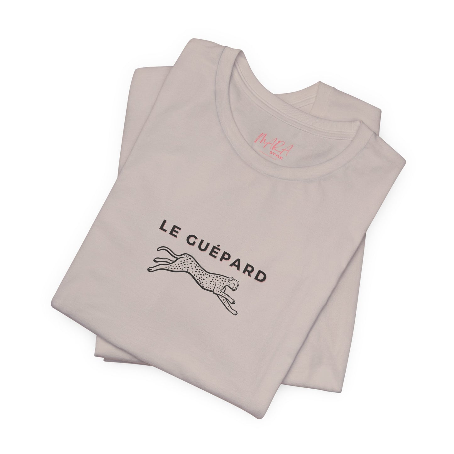 Folded beige t-shirt with 'Le Guépard' text and leaping cheetah graphic on a white background