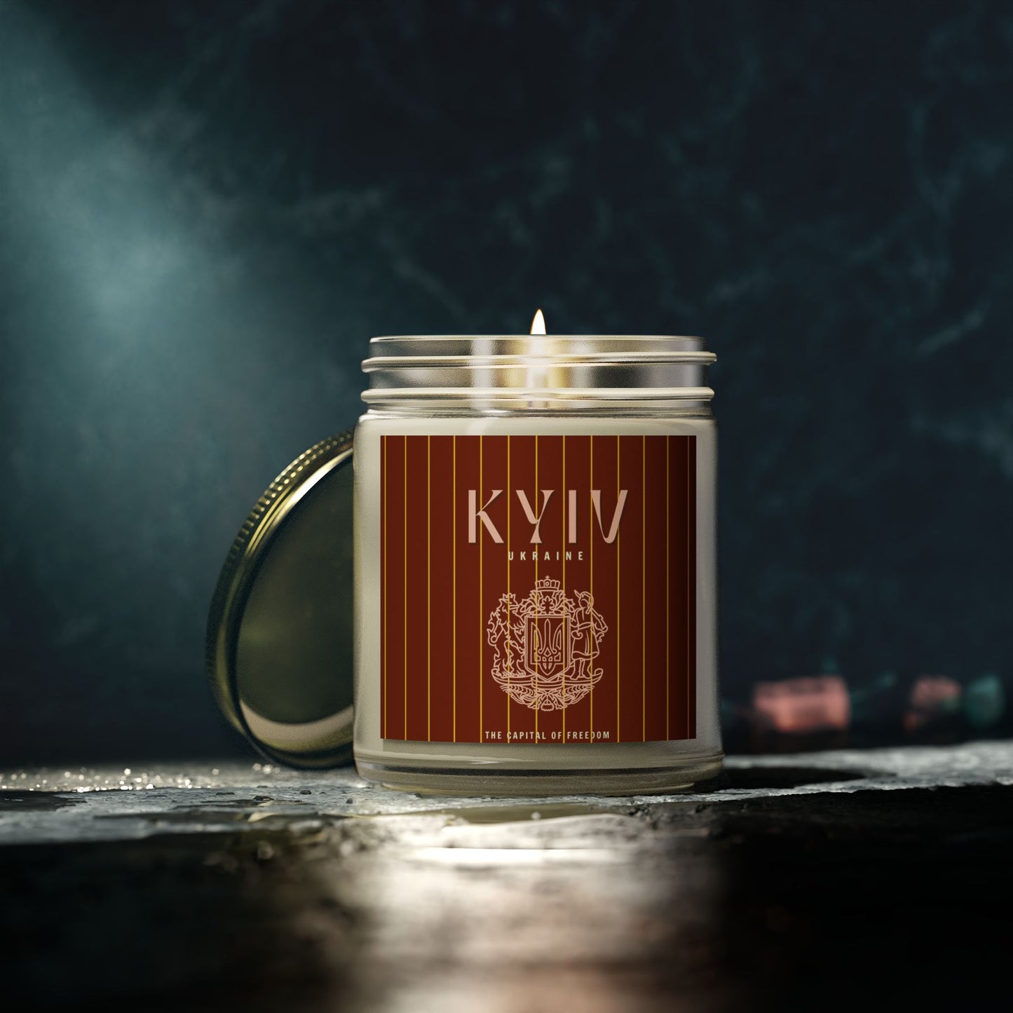 Candle in a jar with 'KYIV' branding on a dark background
