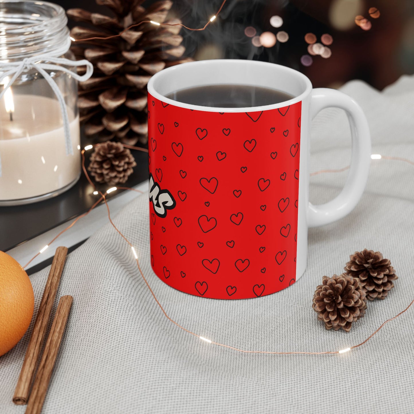 Red mug with heart pattern on a table with decorative items