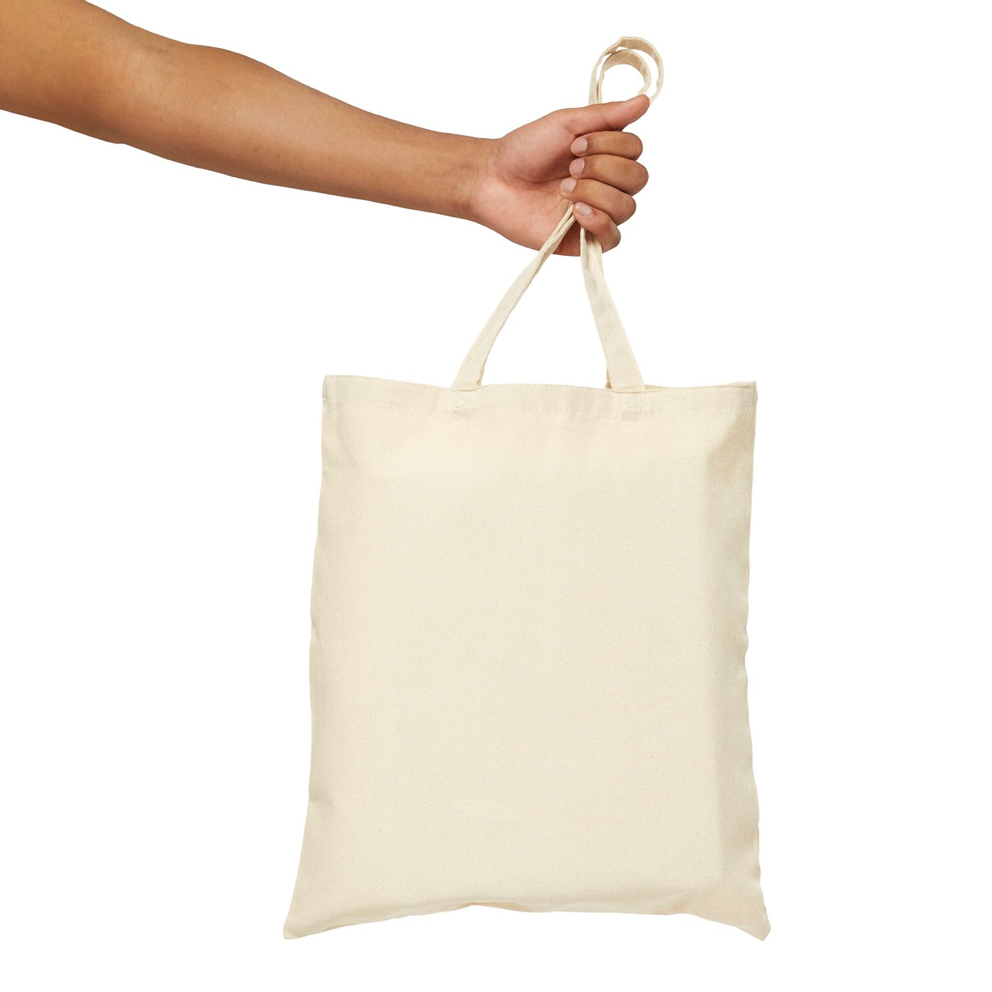 Hand holding a beige tote bag against a white background