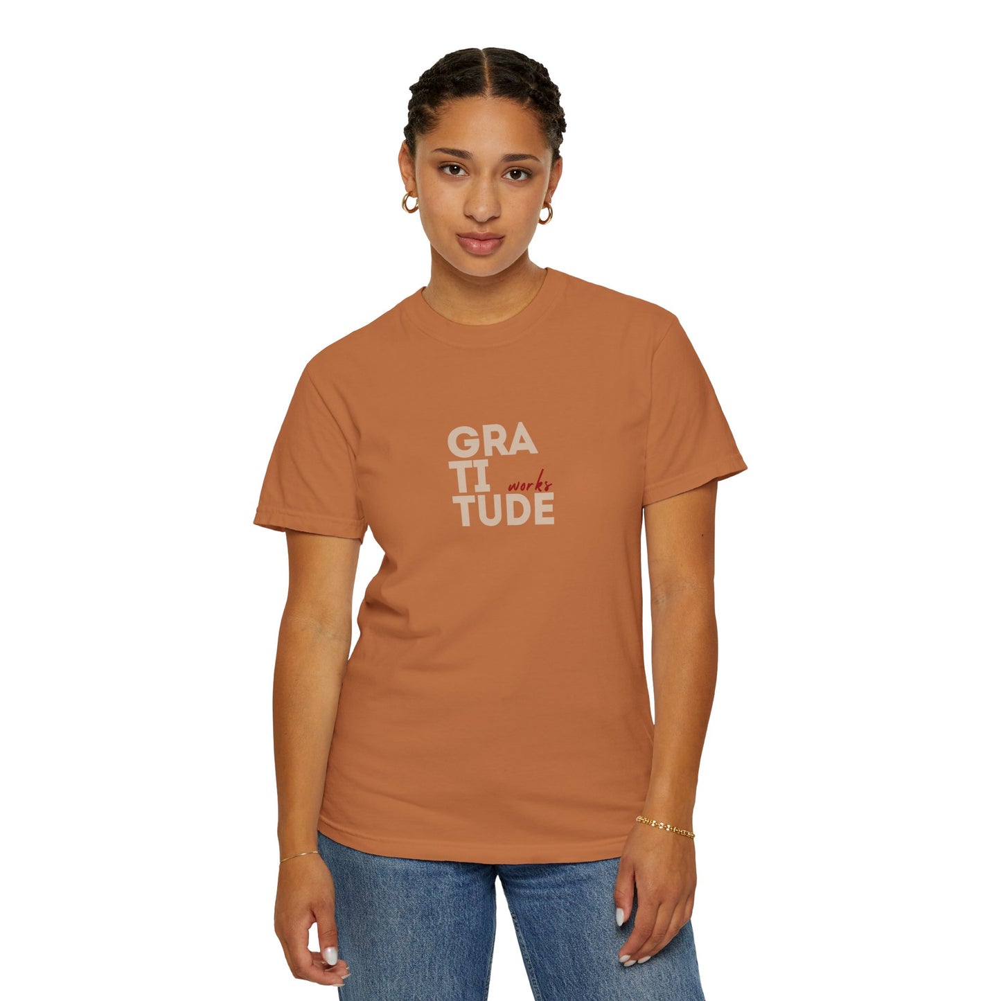 Person wearing a brown t-shirt with 'GRATITUDE' text on a white background