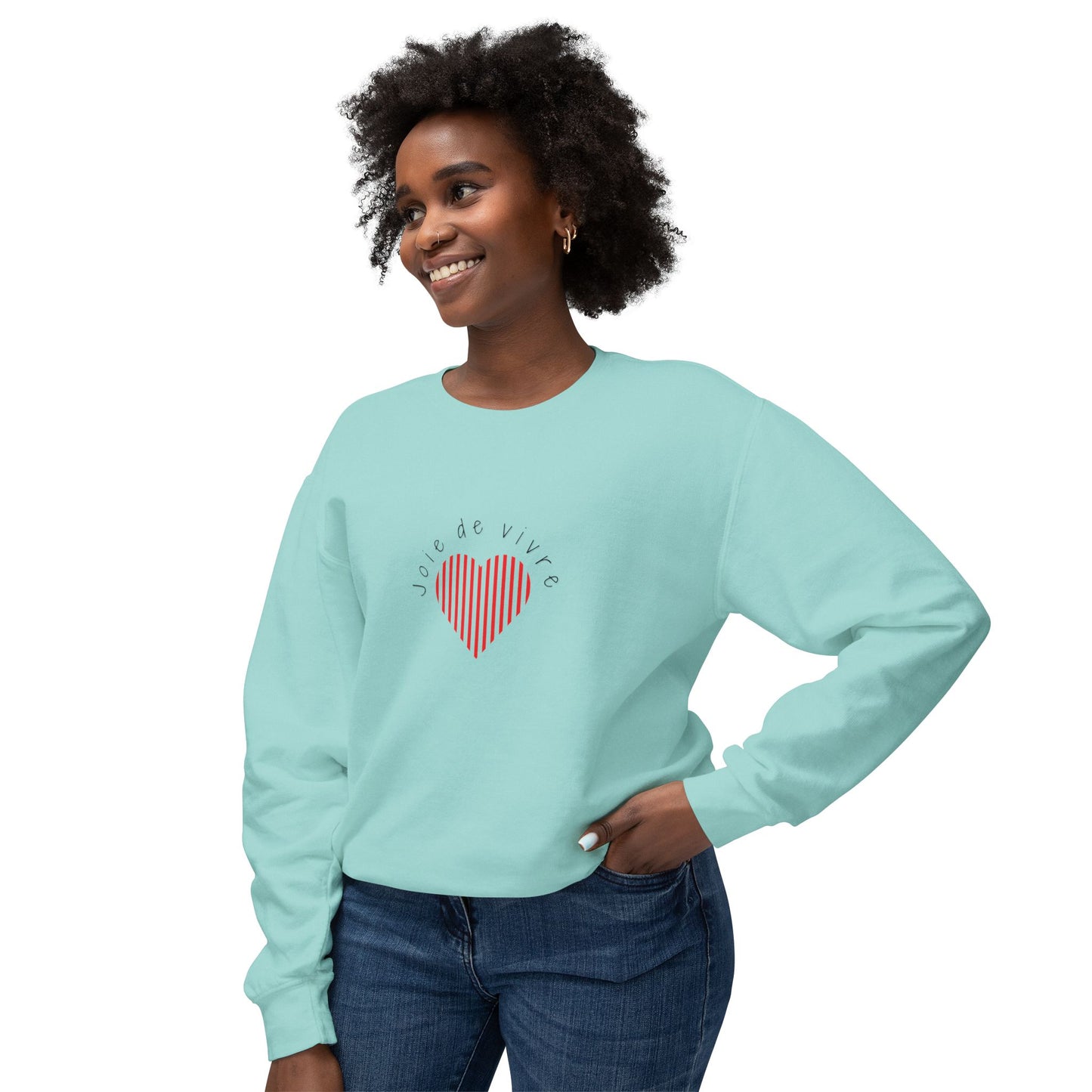 Woman wearing a light blue sweatshirt with a red heart design on a white background