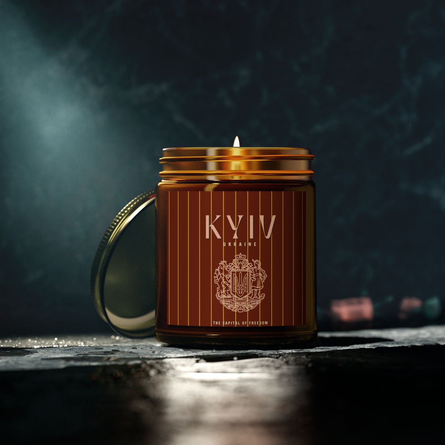 Candle in a brown jar with gold lid on a dark background